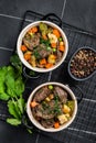 Beef bourguignon meat stew with vegetables, mushrooms and red wine in a pot. Black background. Top view Royalty Free Stock Photo