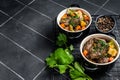 Beef bourguignon meat stew with vegetables, mushrooms and red wine in a pot. Black background. Top view. Copy space Royalty Free Stock Photo