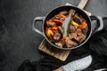 Beef bourguignon stew with vegetables, in cast iron frying pan, on black stone background, with copy space for text Royalty Free Stock Photo