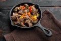 Beef bourguignon stew with vegetables, in cast iron frying pan, on old dark  wooden table Royalty Free Stock Photo