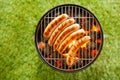 Beef bratwurst grilling over a barbecue fire Royalty Free Stock Photo