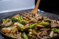 Beef broccoli and onion stirfry steaming in pan