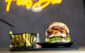 Beef burger and chunks chicken with a potato cart with jars of salt