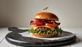 Beef burger with crispy bacon and vegetables on a wooden serving board. Royalty Free Stock Photo