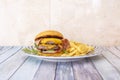 Beef burger with double meat, melted cheddar cheese and slices of fried bacon Royalty Free Stock Photo