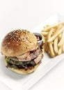 Beef burger with french fries platter on white table