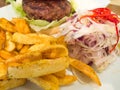 Beef burger with french fries and sliced raw cabbage Royalty Free Stock Photo