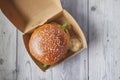 beef burger and french fries in a takeaway paper box on table Royalty Free Stock Photo