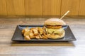 Beef burger with melted cheese with foie gras and fried bacon, french fries Royalty Free Stock Photo