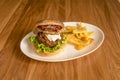 Beef burger with a piece of foie on the edge, lettuce, sauce, caramelized onion Royalty Free Stock Photo