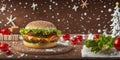 Beef burger with salad leaf,cherry tomatoes,cheese on white wooden table with snowy background.Christmas New Year Banner Royalty Free Stock Photo
