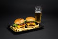 Beef burgers with french fries in a black plate Royalty Free Stock Photo