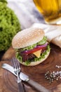 Beef burgers on a wooden board with chips and aromatic spices. Royalty Free Stock Photo