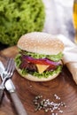 Beef burgers on a wooden board with chips and aromatic spices. Royalty Free Stock Photo