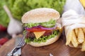 Beef burgers on a wooden board with chips and aromatic spices. Royalty Free Stock Photo