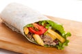 Beef burrito with peppers, fried potato and tomato Royalty Free Stock Photo