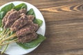 Beef cabobs on the fresh spinach leaves Royalty Free Stock Photo