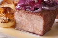 Beef with caramelized red onion on a plate macro. horizontal Royalty Free Stock Photo