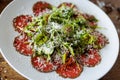 Beef carpaccio. Borettane onion, sun-dried tomato, truffle dressing, arugula salad, parmesan cheese. Italian traditional