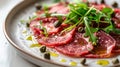 Beef carpaccio dish with arugula and capers on a plate. Royalty Free Stock Photo