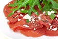 Beef carpaccio with pepper, rucola and parmesan Royalty Free Stock Photo