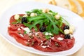 Beef carpaccio with pepper, rucola and parmesan Royalty Free Stock Photo