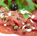 Beef carpaccio with pepper, rucola and parmesan Royalty Free Stock Photo