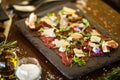 Beef carpaccio with pepper, rucola and parmesan served on a board. Delicious healthy Italian traditional antipasti Royalty Free Stock Photo