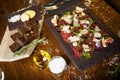 Beef carpaccio with pepper, rucola and parmesan served on a board. Delicious healthy Italian traditional antipasti Royalty Free Stock Photo