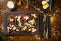 Beef carpaccio with pepper, rucola and parmesan served on a board. Delicious healthy Italian traditional antipasti Royalty Free Stock Photo