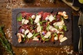 Beef carpaccio with pepper, rucola and parmesan served on a board. Delicious healthy Italian traditional antipasti Royalty Free Stock Photo