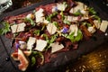 Beef carpaccio with pepper, rucola and parmesan served on a board. Delicious healthy Italian traditional antipasti Royalty Free Stock Photo