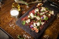 Beef carpaccio with pepper, rucola and parmesan served on a board. Delicious healthy Italian traditional antipasti Royalty Free Stock Photo