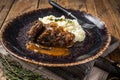 Beef cheeks stewed in red wine sauce with mashed potatoes. Wooden background. Top view