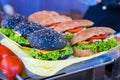 Beef and cheese burgers with green salad and sauce and tasty sandwich at street food festival