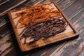 Beef and chiken jerky on wooden