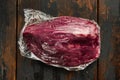 Beef cut in vacuum, on old dark  wooden table background Royalty Free Stock Photo