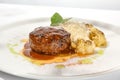 Beef cutlet with grilled cauliflower with gravy and cheese sauce on white plate. Elegant beefsteak on light background with