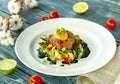 Beef cutlet with mashed potatoes, garnished with microgreens, tomatoes, egg yolk and black sauce Royalty Free Stock Photo