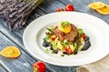 Beef cutlet with mashed potatoes, garnished with microgreens, tomatoes and egg yolk Royalty Free Stock Photo