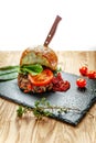 Beef cutlet with tomatoes with roll from hamburger and fresh vegetables without harmful additives for healthy nutrition Royalty Free Stock Photo