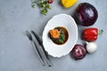 Beef in dark sauce with spinach. Dish of meat with vegetables on a gray table. Background for the menu. View from above Royalty Free Stock Photo