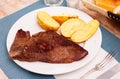 Beef entrecote with baked potato in skins Royalty Free Stock Photo