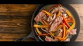 beef fajita platter with copy space on wooden brown background, top view