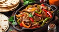 Beef Fajitas with colorful bell peppers in pan and tortilla bread and sauces Royalty Free Stock Photo