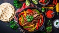 Beef Fajitas with colorful bell peppers in pan and tortilla bread and sauces Royalty Free Stock Photo