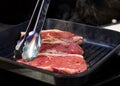 Beef fillet on grill , Beef steaks being prepared on grill , cooking meat steaks on kitchen Royalty Free Stock Photo