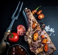 Beef grilled steak served with tomatoes, chili pepper and sauce Royalty Free Stock Photo