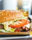 Beef hamburger with cheese and bacon, lettuce in box of a Burger restaurant Royalty Free Stock Photo