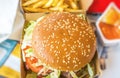 Beef hamburger with cheese and bacon, lettuce in box of a Burger restaurant Royalty Free Stock Photo